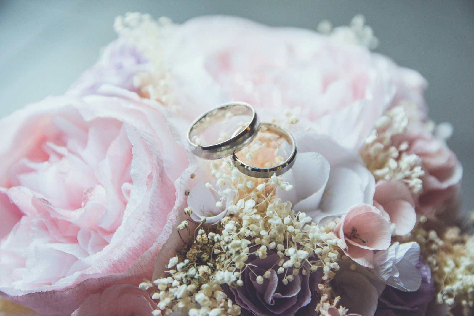 Wedding rings on a rose bouquet
