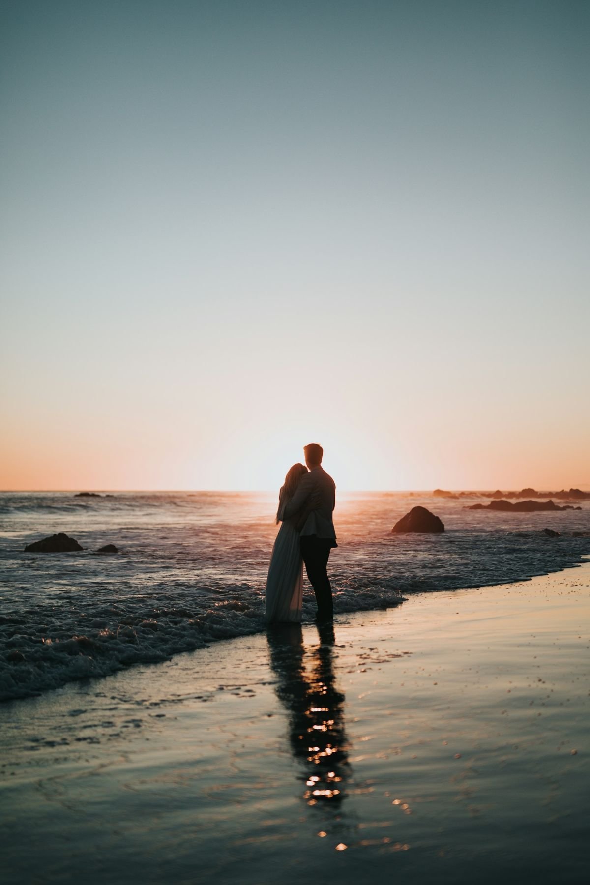 Couple silhouette on a beach at sunset
