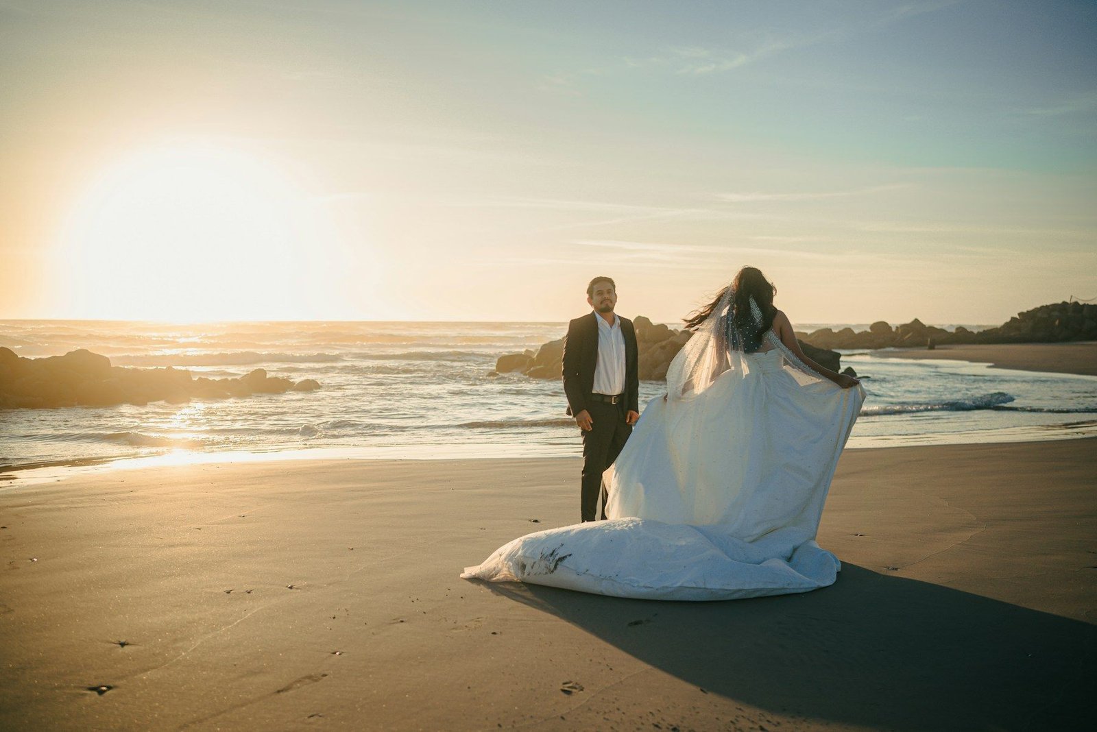 Bride and groom on the beach at sunset