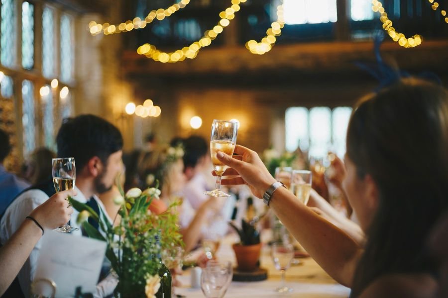 Guests raising glasses for a wedding toast
